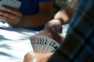 A person holding a stack of cards during a betting game