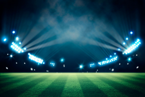A cricket stadium with lights at night