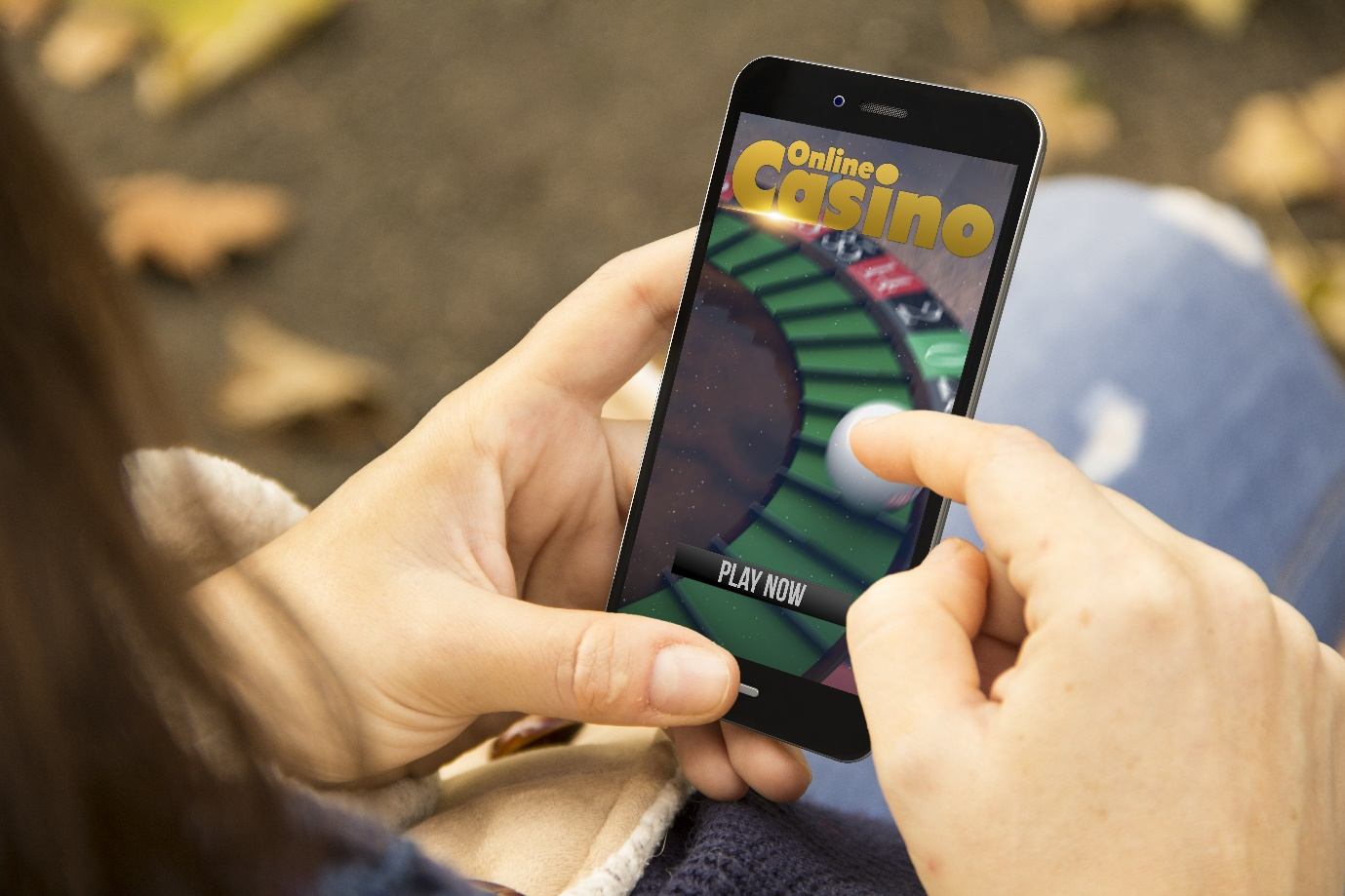 a woman holding a smartphone with an online casino website on the screen